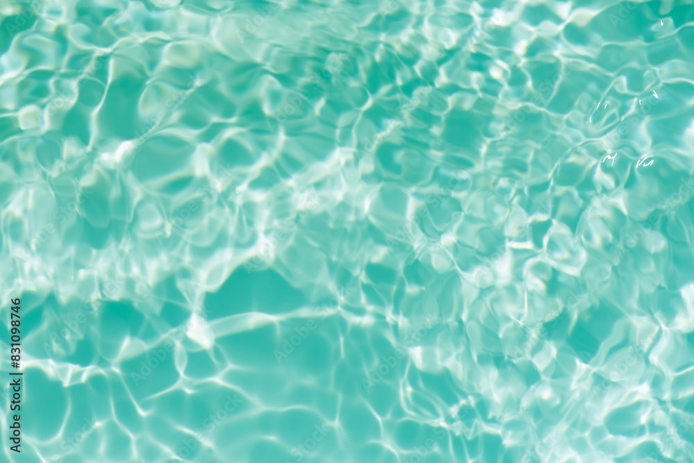 Blue water with ripples on the surface. Defocus blurred transparent blue colored clear calm water surface texture with splashes and bubbles. Water waves with shining pattern texture background. Blue water with ripples on the surface. Defocus blurred transparent blue colored clear calm water surface texture with splashes and bubbles. Water waves with shining pattern texture background.