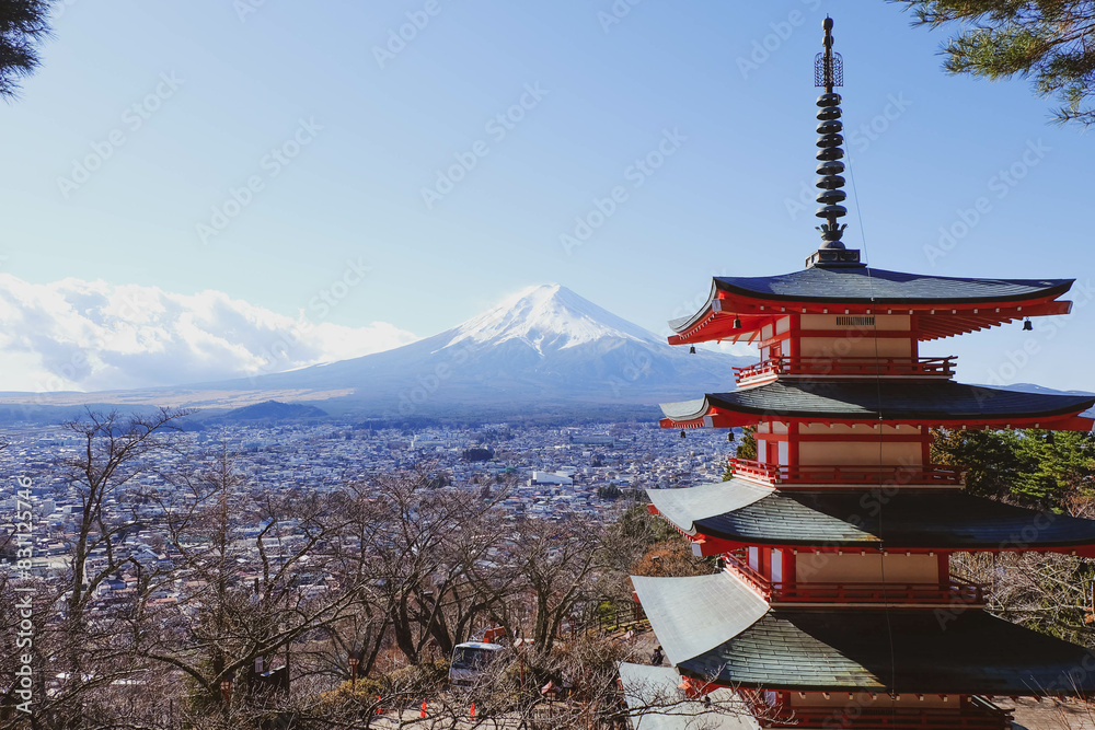 The iconic view of Mount Fuji with the red Chureito pagoda and Fujiyoshida city from Arakurayama sengen park in Yamanashi Prefecture, Japan.