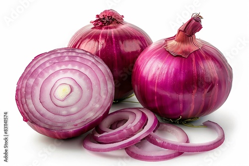 Two whole onions and one sliced onion on table