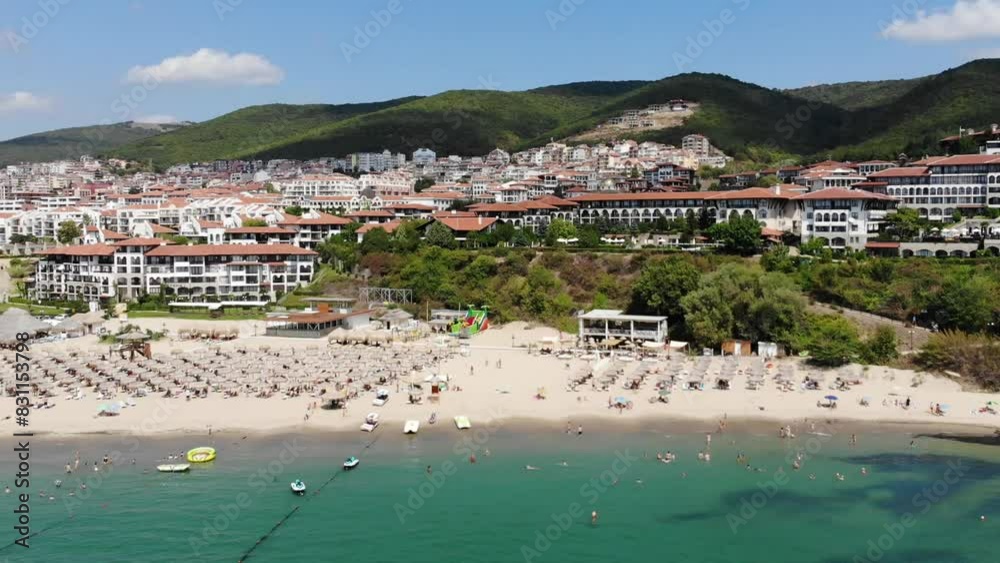 Aerial drone view from above of sunbeds, sun umbrellas and beach in Sveti Vlas, houses and hotels in the background. Panoramic view of resort in Sveti Vlas in Bulgaria, Black Sea. Summer holiday in Eu
