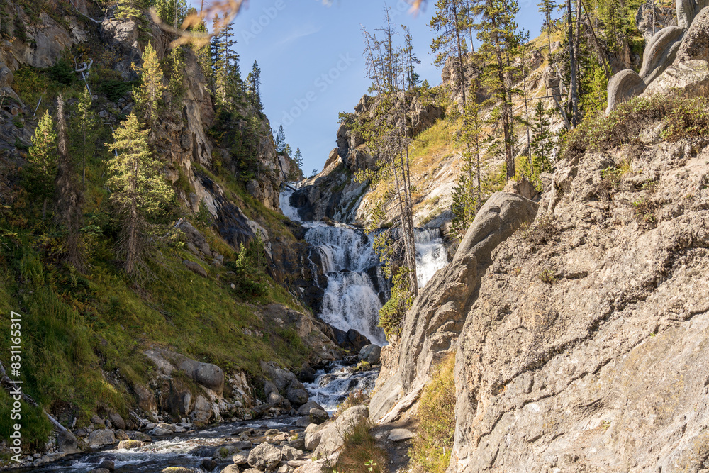 Mystic Falls on the Firehole River in Yellowstone National Park in Wyoming on a sunny fall day Mystic Falls on the Firehole River in Yellowstone National Park in Wyoming on a sunny fall day