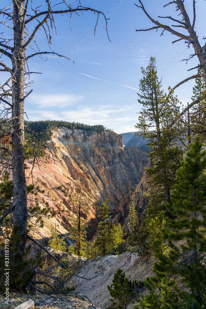 Early morning light on the rocks and cliffs at the Grand Canyon of the Yellowstone at Canyon Village in Yellowstone National Park in Wyoming on a sunny day Early morning light on the rocks and cliffs at the Grand Canyon of the Yellowstone at Canyon Village in Yellowstone National Park in Wyoming on a sunny day
