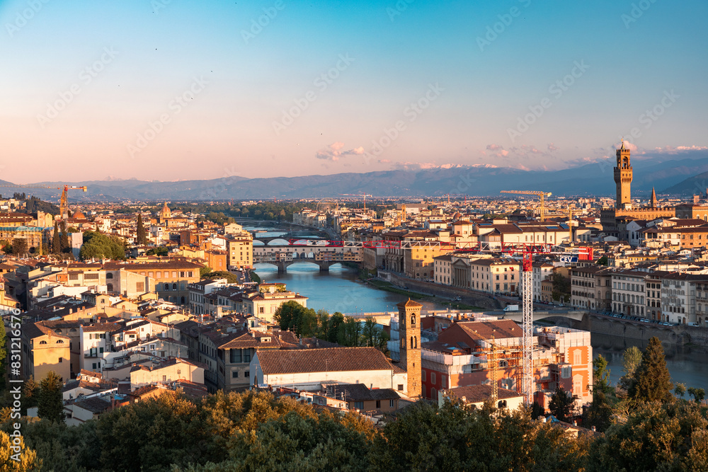 Sunrise view of the city center of Florence and the Ponte Veccio bridge from the Vista panoramica di Firenze in Italy during the spring time.