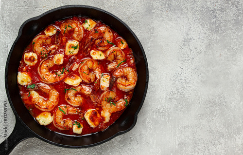 Greek saganaki, in an iron pan, saganaki with shrimp, shrimp in tomato sauce, with pepper and feta cheese, homemade, no people,