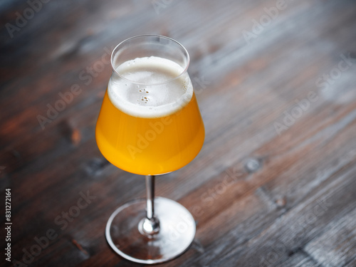 Craft beer in a Teku glass on a wooden table. copy space photo