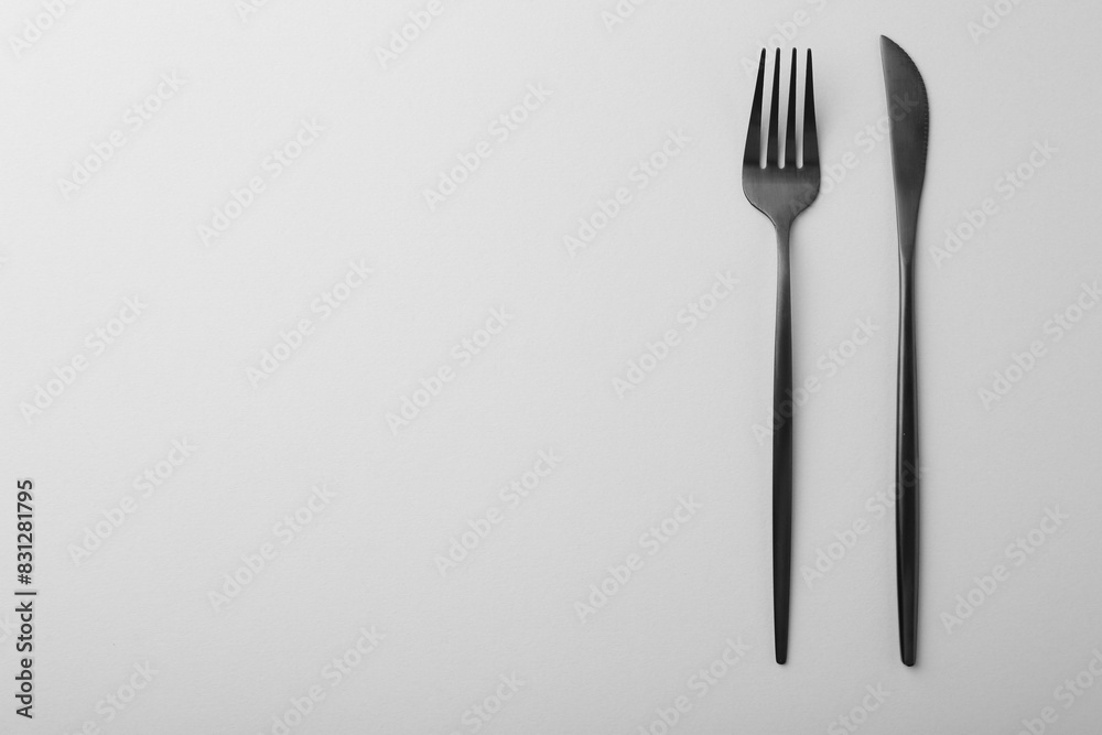 Stylish cutlery on grey table, top view. Space for text Stylish cutlery on grey table, top view. Space for text