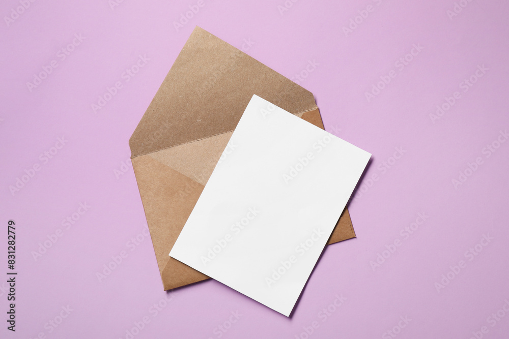 Letter envelope and card on violet background, top view. Space for text Letter envelope and card on violet background, top view. Space for text