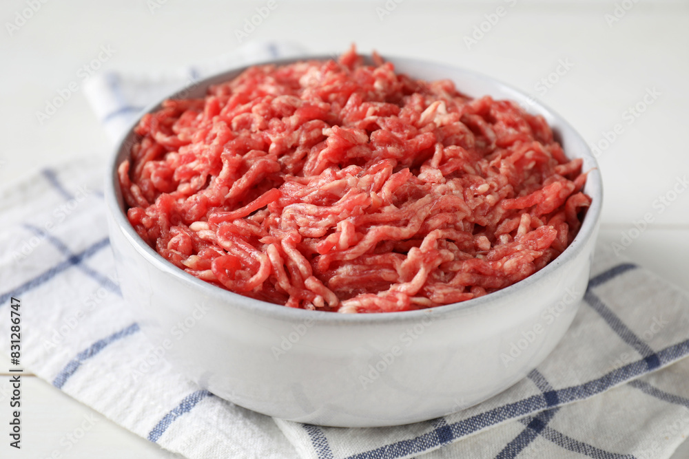 Raw ground meat in bowl on table, closeup Raw ground meat in bowl on table, closeup
