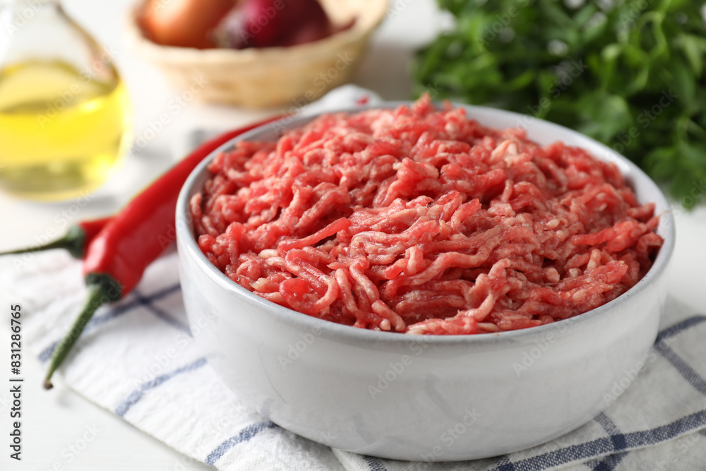 Raw ground meat in bowl on table, closeup Raw ground meat in bowl on table, closeup