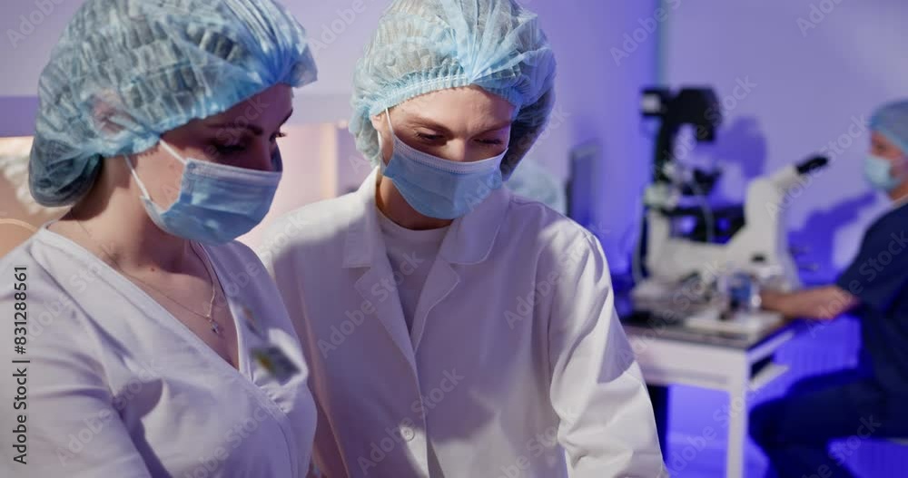 Embryologists conducting artificial fertilization of human eggs in a laboratory, showcasing precision and advanced reproductive technology. Embryologists Performing Artificial Fertilization