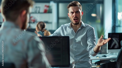 A man is angry and yelling at another man in an office photo