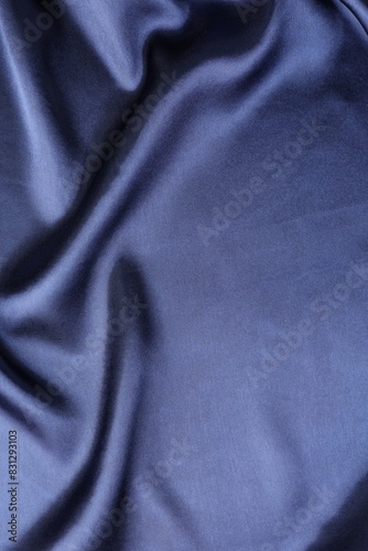 Crumpled dark blue silk fabric as background, top view