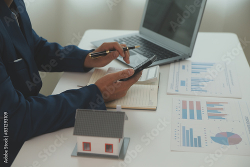 Bild auf Leinwand Businessmen holding pens, signing home titles with insurance, care about real estate services and the idea of real estate agents offering interest in installments to their customers