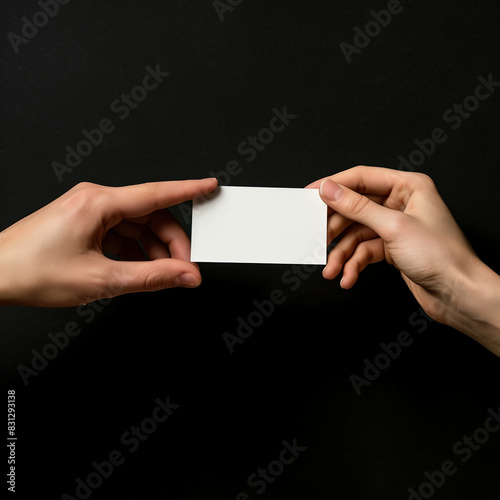 A blank business card mockup is passed from one hand to another