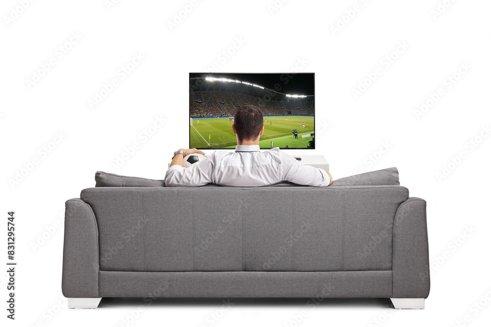© Ljupco Smokovski - Man sitting on a sofa with a football and watching a match on tv © Ljupco Smokovski - Man sitting on a sofa with a football and watching a match on tv