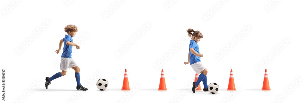 Boy and girl running with footballs between cone obstacles