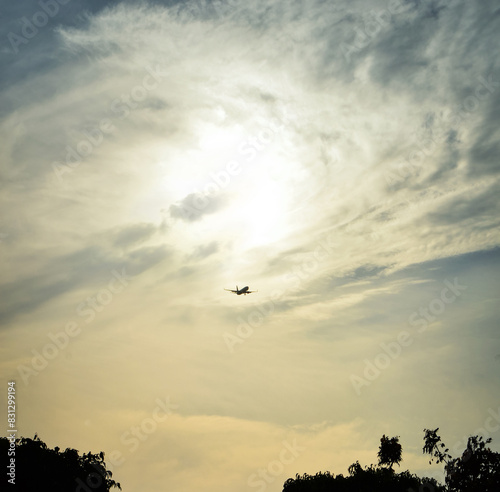 Silhouette of an airliner flying against a beautiful sunset sky