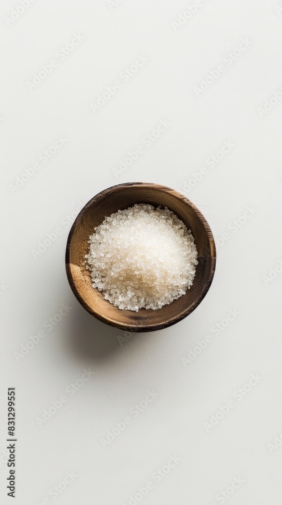 Wooden bowl filled with coarse sugar substitute granules on a white background. Ideal for low-calorie and sugar-free diets. Wooden bowl filled with coarse sugar substitute granules on a white background. Ideal for low-calorie and sugar-free diets.