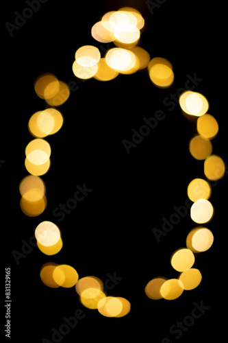 Golden blurred bokeh lights on black background. Christmas lights overlay.