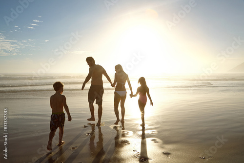 Family, beach and holding hands by ocean for holiday, vacation and summer together in silhouette. Parents with children by sea and sunshine for support, game and playing with love or travel adventure