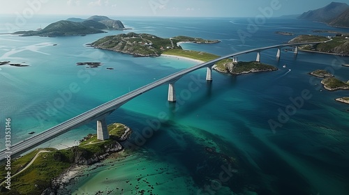 Aerial Bird s-Eye View of the Confident Bridge Connecting Lofoten Archipelago to Northern Norway Islands with Clear Water  Greenery  and Vast Blue Sky. Captured Using Wide-Angle Lens and High-Resoluti