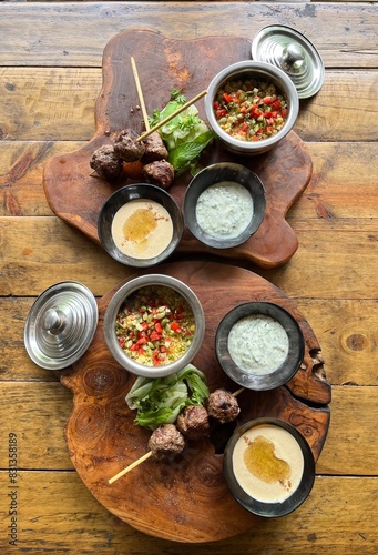 Kebab with bulgur and couscous, hummus, spices and herbs