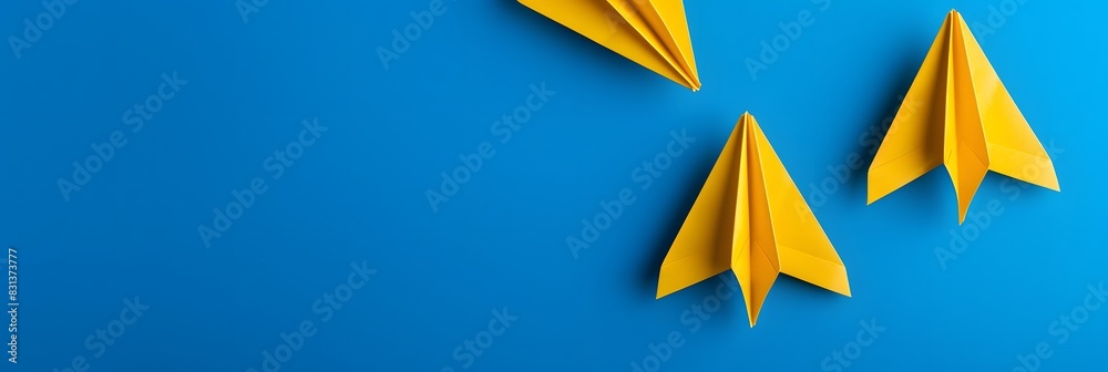 Three Yellow Paper Airplanes on Blue Background, Business Concept Three Yellow Paper Airplanes on Blue Background, Business Concept