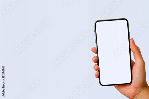 Hand holding a smartphone with a blank screen photo