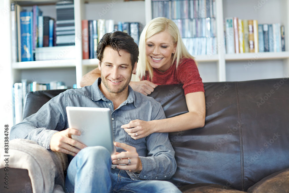 Happy, couple and home sofa with tablet or relaxing online, people smile and internet browse together on social media. Web, scrolling and relationship bonding, networking and communication apartment