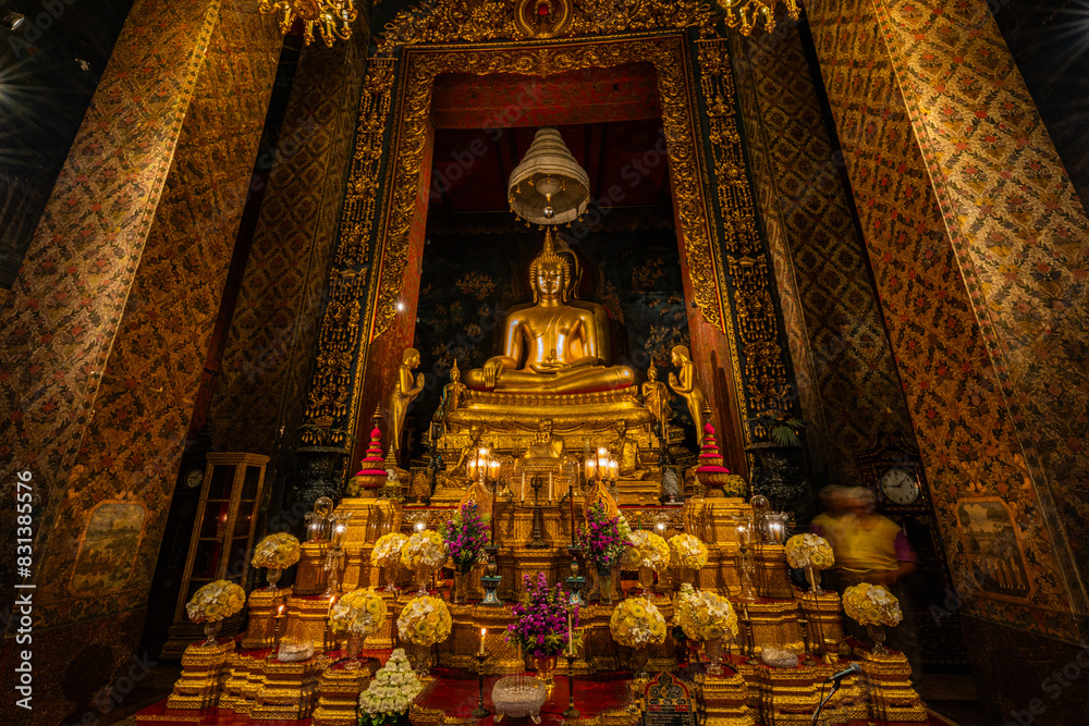 Fototapeta premium The gold Buddha image in the chapel in Wat Bowonniwet Vihara is set up and beautifully decorated to serve as an object of worship. and is the main Buddha image for prayers and various ceremonies