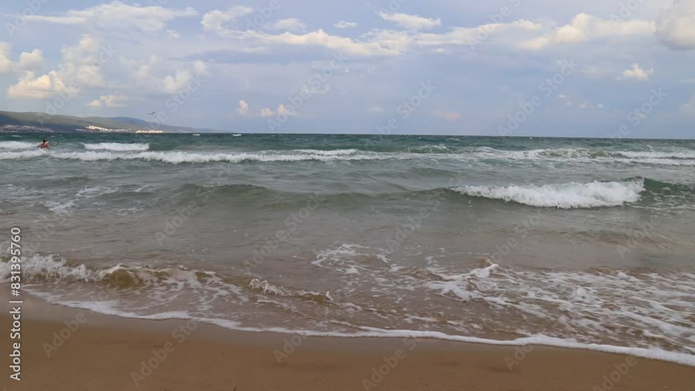 Beautiful sea waves on seashore, foam of sea water. Cloudy sky, thunderstorm, storm, bad weather, Nessebar, Bulgaria Beautiful sea waves on seashore, foam of sea water. Cloudy sky, thunderstorm, storm, bad weather, Nessebar, Bulgaria