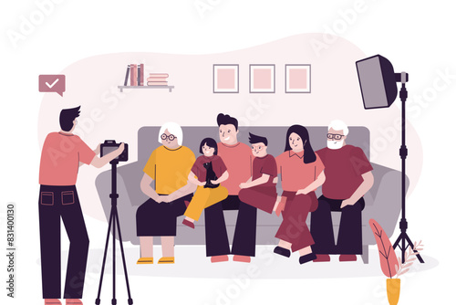 Happy family portrait, people sitting on sofa and photographer taking photos. Grandparents, father, mother, son and daughter together before camera.