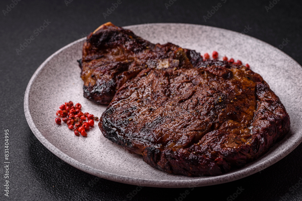 Delicious juicy beef ribeye steak grilled with salt, spices and herbs Delicious juicy beef ribeye steak grilled with salt, spices and herbs