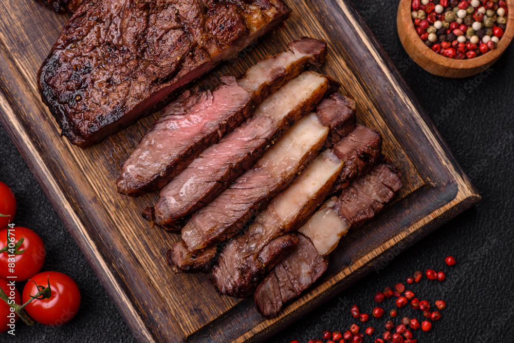 Delicious juicy beef ribeye steak grilled with salt, spices and herbs Delicious juicy beef ribeye steak grilled with salt, spices and herbs