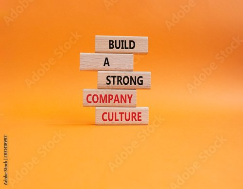 Company culture symbol. Wooden blocks with words Build a strong company culture. Beautiful orange background. Business and Company culture concept. Copy space.