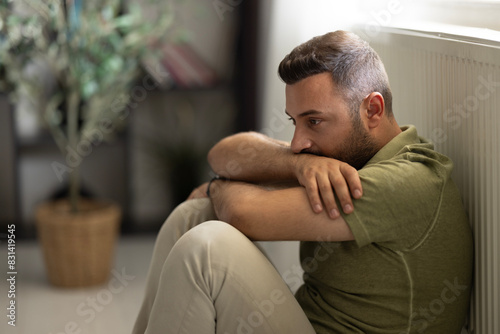 Schilderij op canvas Man sitting alone at home looking sad and distraught