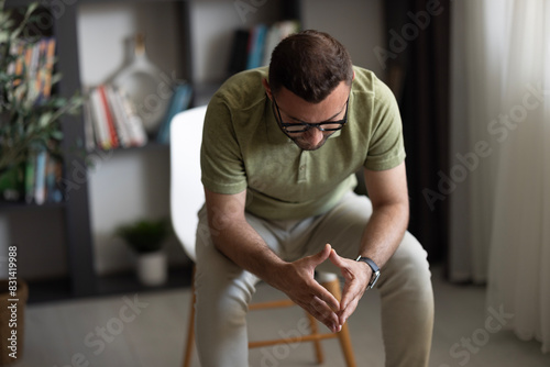 Man sitting alone at home looking sad and distraught