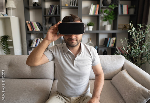 Young man experiencing virtual reality at home