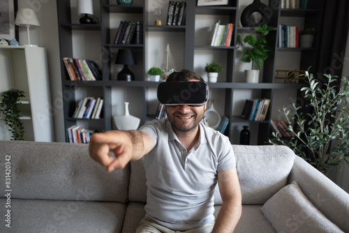 Young man experiencing virtual reality at home