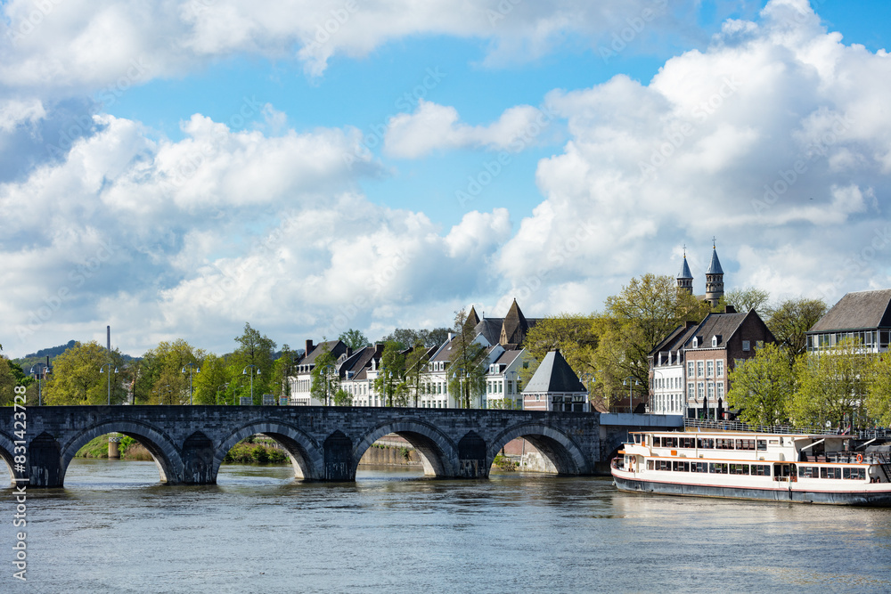 Fototapeta premium European city Maastricht, riverfront Servaas bridge and boats