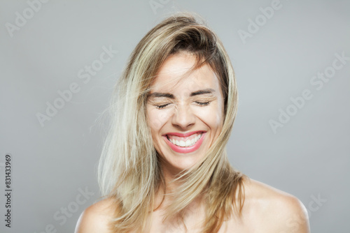 Beautiful girl fashion portrait with windy hair. Looking at camera.