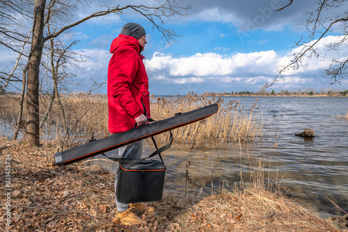 Fisherman with fishing case and bag for equipment and tackles before fishing