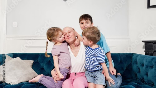Ill mother smiling has emotional support from her three children