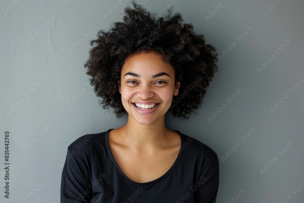 Tooth Wear. Joyful Young Woman in Casual Black Clothes Smiling Happily at Camera on Grey Background Tooth Wear. Joyful Young Woman in Casual Black Clothes Smiling Happily at Camera on Grey Background