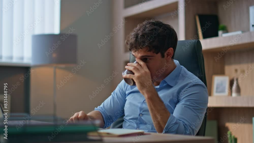Relaxed businessman drinking coffee in office room. Handsome brunette resting Relaxed businessman drinking coffee in office room. Handsome brunette resting
