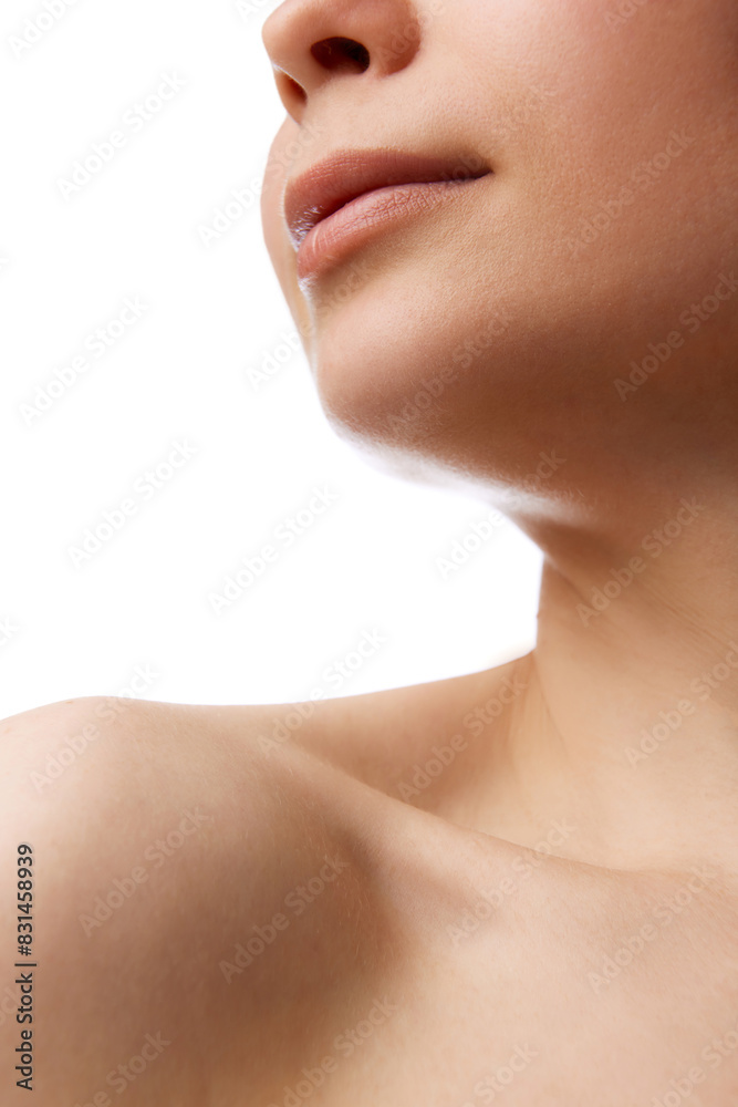 Cropped close-up image of female face and bare shoulders isolated on white background. Smooth moisturized skin. Concept of natural beauty, skincare, wellness, cosmetology, cosmetics
