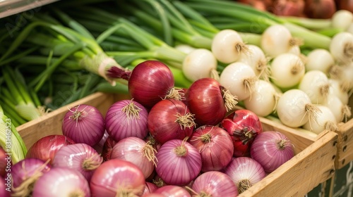 Display of fresh red onions and spring onions