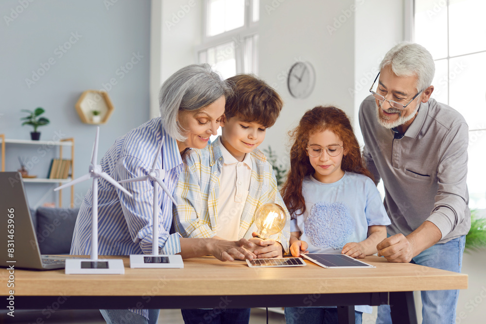 Curious grandparents, with grandchildren, explore solar panels and alternative energy sources at home. Family bonding activity involves learning about sustainable energy technology. Curious grandparents, with grandchildren, explore solar panels and alternative energy sources at home. Family bonding activity involves learning about sustainable energy technology.