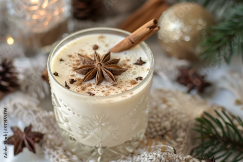 Closeup of creamy eggnog with cinnamon, surrounded by holiday decorations photo