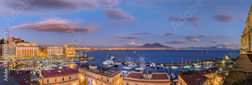 Naples, Italy. Splendid panoramic view from Castel dell'Ovo over the city and Borgo Marinari after sunset. Marina on Via Partenope with luxury hotels. Mount Vesuvius in the distance. 2012-12-19. photo